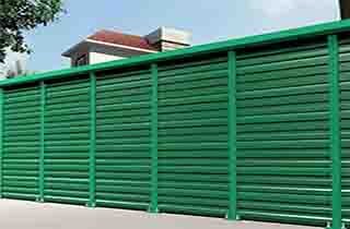 FRP noise reduction barrier panels and structural vertical support posts installed for utility infrastructure screening and environmental noise control.